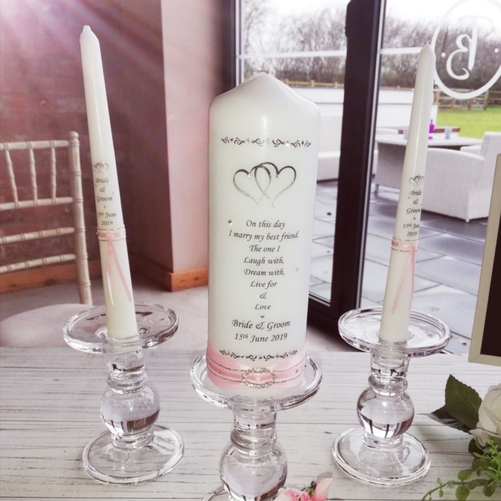 White Examples of a Unity candle set with pink ribbon for a mini ceremony in a wedding
